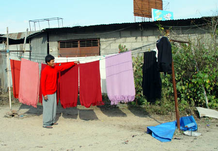 Suman checking whether the shawls are dry.