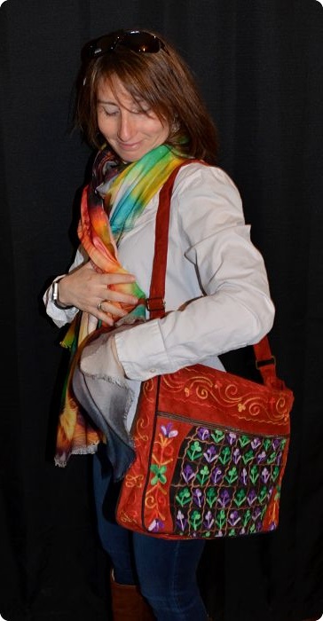Empar is carrying a handcrafted Nasjola purse, and she is wearing a multicolor Ranghi-Tanghi modal shawl